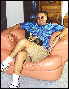 Macqui loves to cuddle - here she is with Wesley watching the Summer 2000 Olympics!!